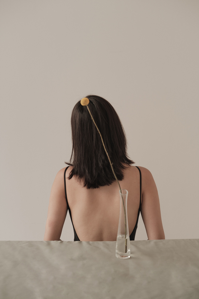 Back of a Woman and Small Flower on Vase